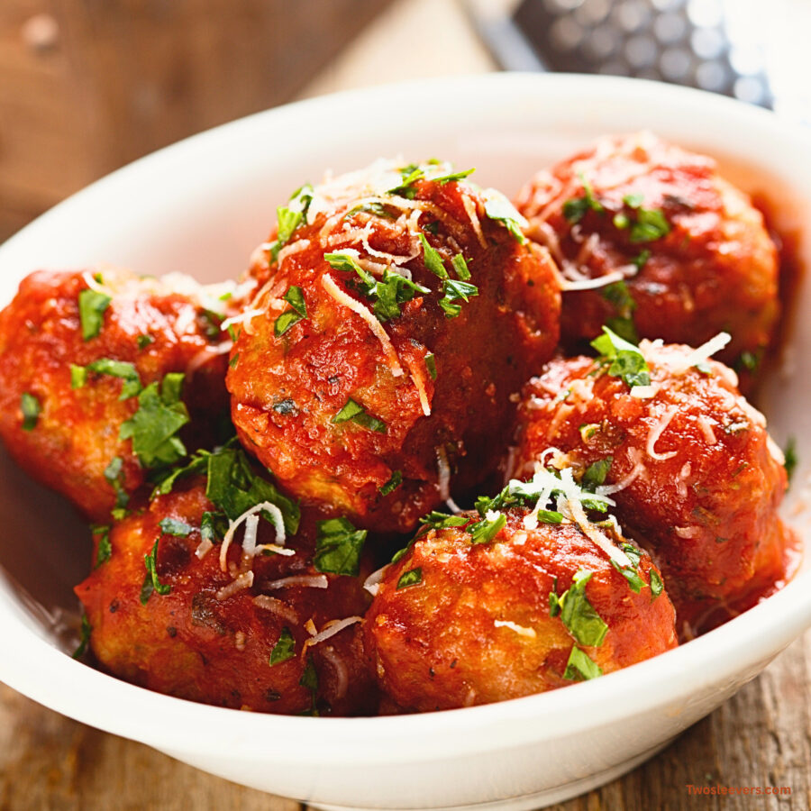 Close up image of slow cooker meatballs in a white bowl