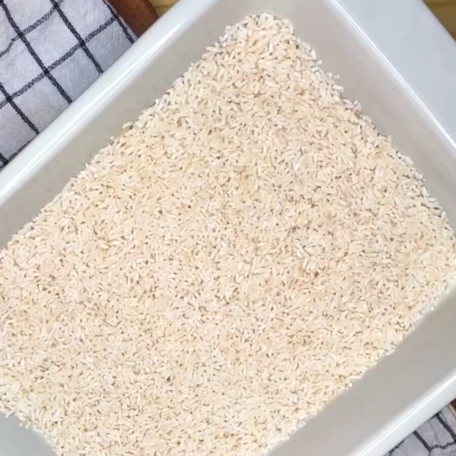 Rinsed white rice in a white baking dish