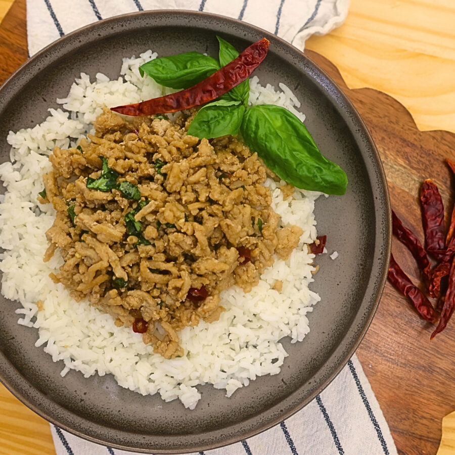 Overhead image of thai basil chicken on a bed of rice 