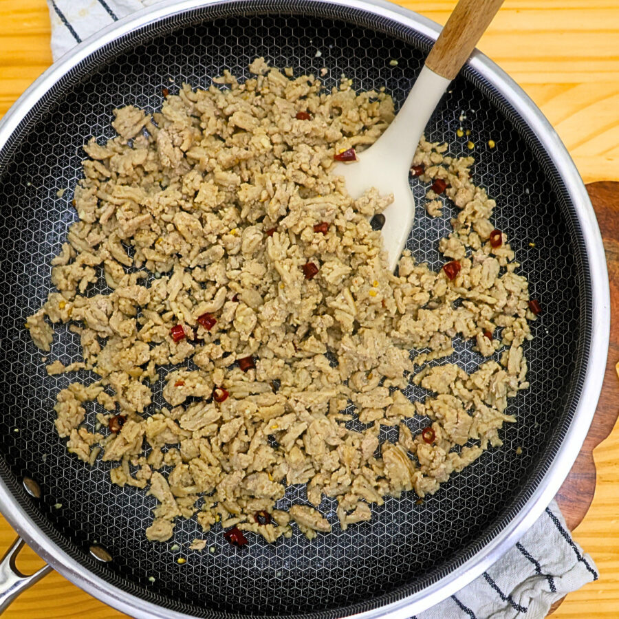 Ground Chicken cooked in a skillet with garlic, onion, and bird's eye chilies