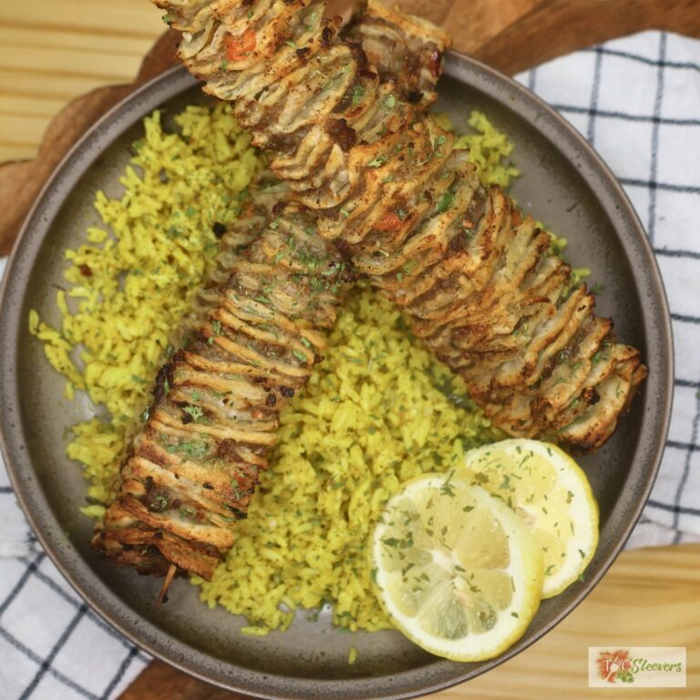 Two Tortilla Kebabs on a bed of seasoned yellow rice with lemon slices