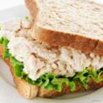 close up image of a tuna salad sandwich on white bread
