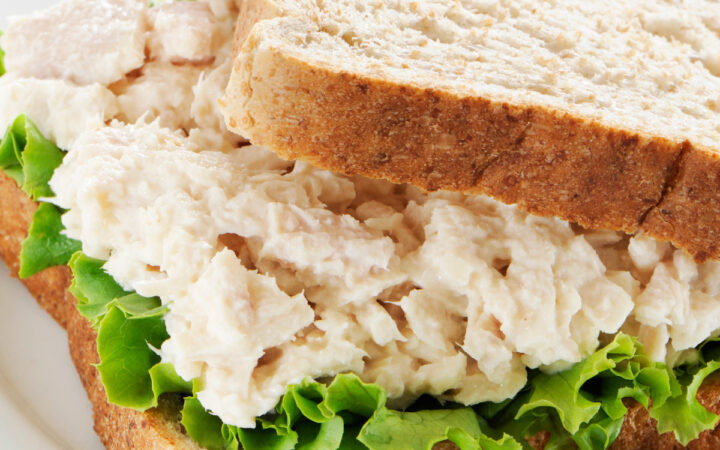 close up image of a tuna salad sandwich on white bread