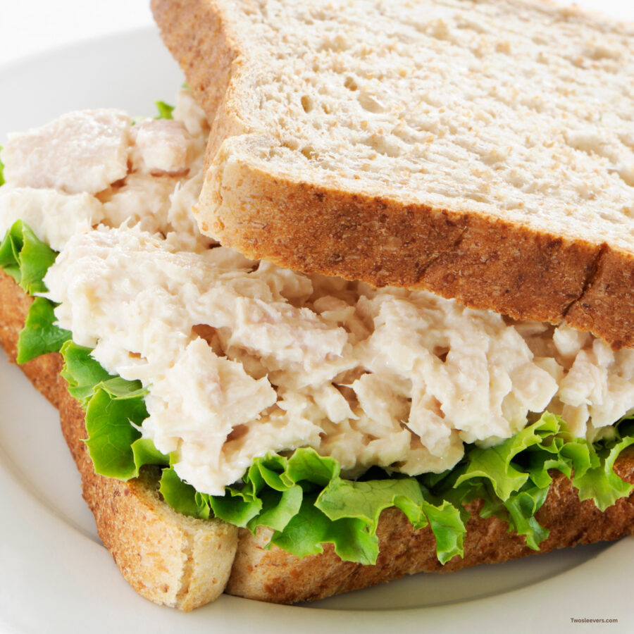 close up image of a tuna salad sandwich on white bread