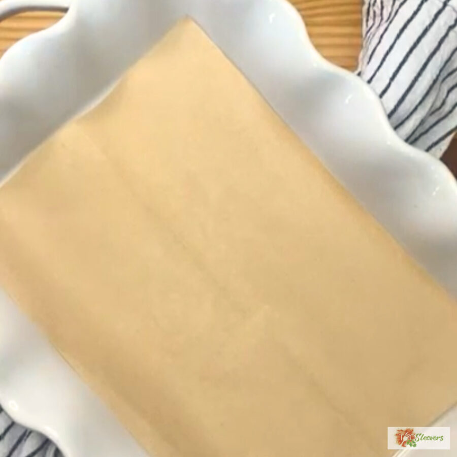 A white baking dish lined with parchment paper