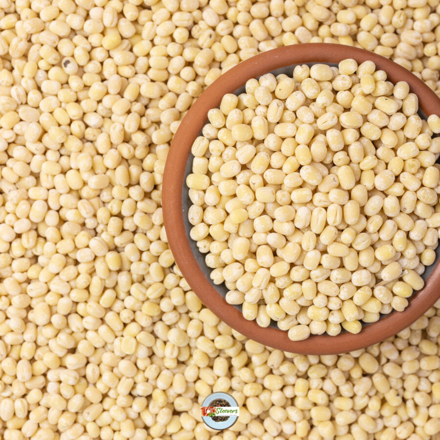 Overhead image of Urad Dal in a bowl with some scattered around it