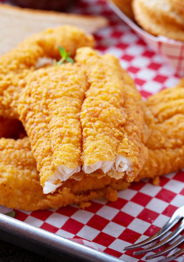 Close up image of air fryer catfish with a bite taken out of it