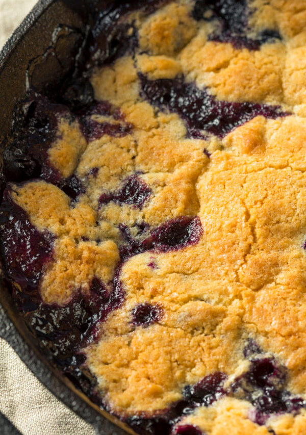 Close up image of Blueberry Cobbler in a cast iron pan