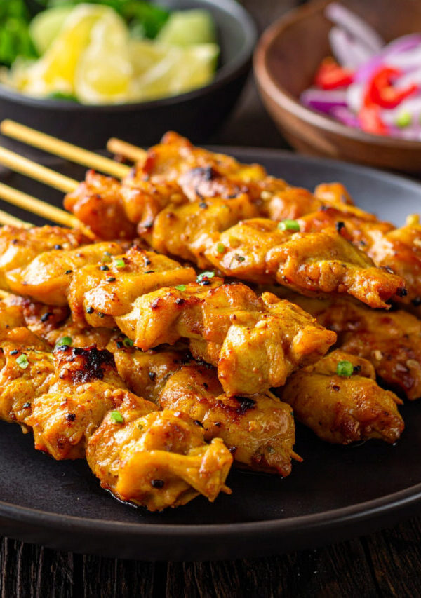 Close up image of Chicken Satay stacked on a plate