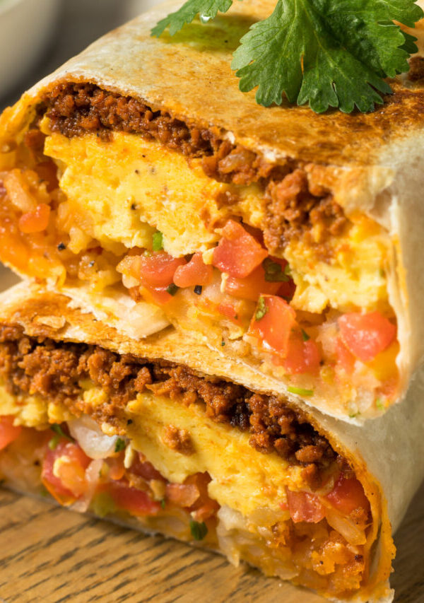 A chorizo breakfast burrito cut in half and stacked on top of each other