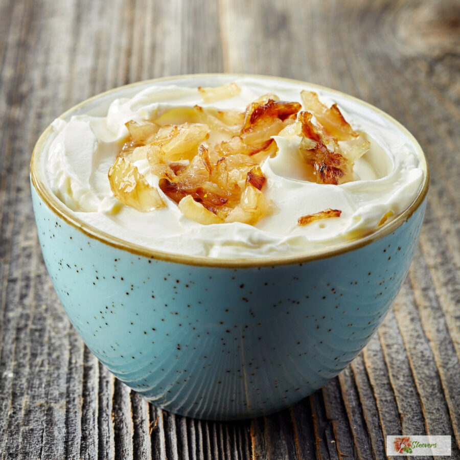 Close up image of French Onion Dip with caramelized onions in a blue bowl