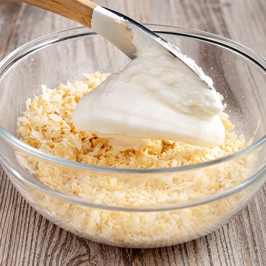 whipped egg whites being mixed into the other ingredients for keto macaroons
