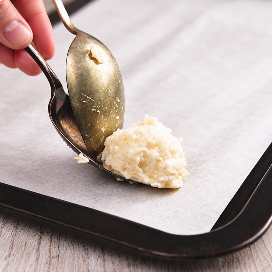 Low carb coconut macaroons being portioned with two spoons