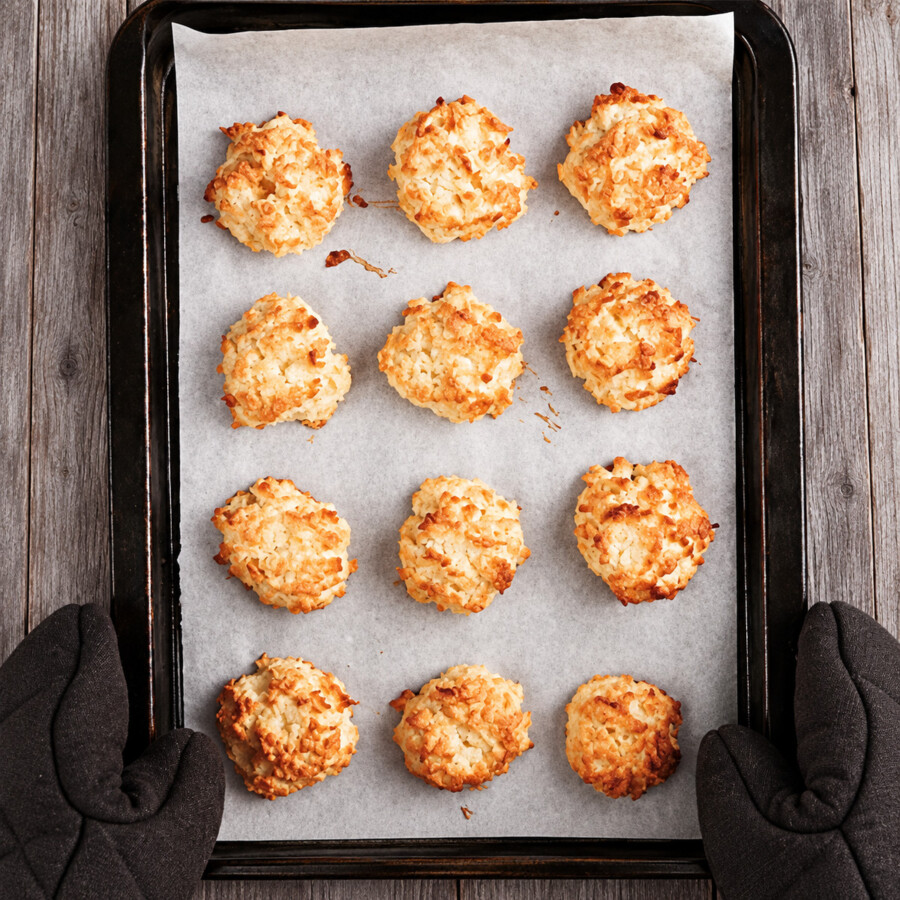 12 keto coconut macaroons baked on a parchment paper lined baking sheet